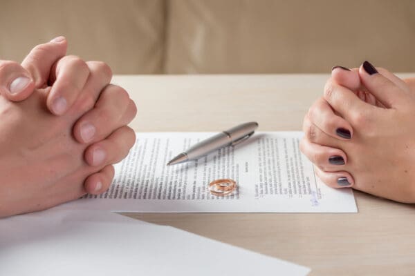 Trimnal & Myers, wife and husband signing divorce documents or premarital agreement